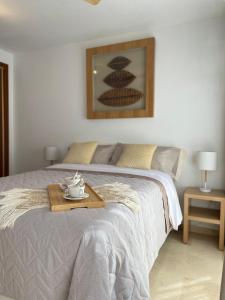 a bedroom with a bed with a tray on it at Ivory Suites in Málaga