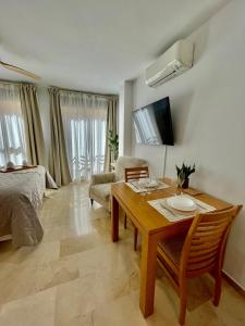 a living room with a table and a couch at Ivory Suites in Málaga