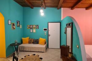 a room with a bed and a colorful wall at casa croma in Siracusa