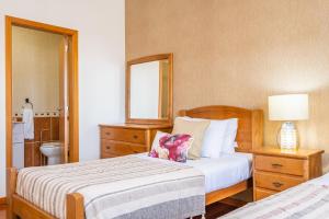 a bedroom with two beds and a mirror at Gaula Residence by Madeira Sun Travel in Santa Cruz