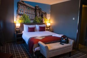 a hotel room with a large bed and a large building at Best Western Glasgow Hotel in Glasgow