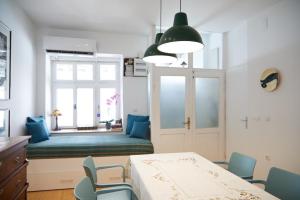 a room with a table and chairs and a window at Ohrid Center Galerie House in Ohrid