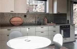 una cucina con tavolo bianco e alcune sedie di Pet Friendly Apartment In Vallda With Wifi a Vallda