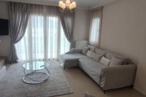 a living room with a couch and a glass table at Η πέρλα της λίμνης/ The lake's pearl in Ioannina