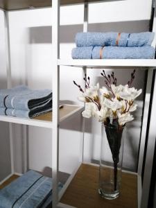 a vase of flowers on a table in a room at Studio Apartman Sun in Jajce +16 photos