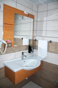 a bathroom with a sink and a mirror at Quars Garden Hotel in Koçyazı