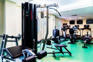 a gym with treadmills and machines in a room at Occidental Cozumel - All Inclusive in Cozumel