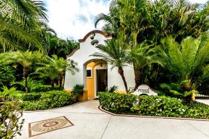 une maison avec des palmiers en face d'une allée. dans l'établissement Occidental Cozumel - All Inclusive, à Cozumel