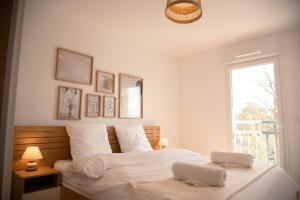 Un dormitorio con una cama con una computadora portátil encima. en Domaine de Milhà, en Labenne