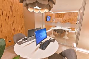 فندق دنفير مار ديل بلاتا في مار ديل بلاتا: طاولة بيضاء وعليها جهاز كمبيوتر