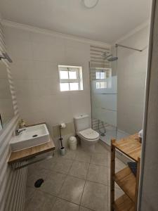 a bathroom with a toilet and a sink and a shower at Villa Vista Mar - Galé - Albufeira in Guia