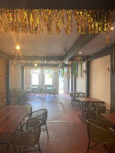 a dining room with tables and chairs and chandeliers at Pousada Bom Sucesso 59 in Olinda