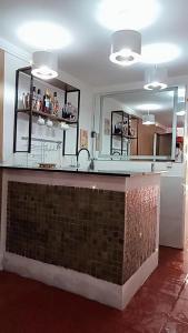 a kitchen with a counter and a mirror at Pousada Bom Sucesso 59 in Olinda