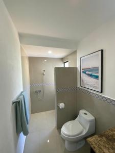 a bathroom with a toilet and a shower at Villas Eco Venture in Playa Junquillal