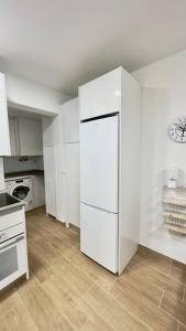 a kitchen with a white refrigerator in a room at Rockside Residences Suites La Línea N3 in La Línea de la Concepción