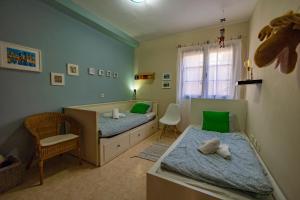 1 dormitorio con 2 camas, silla y ventana en Casa Zora en Agaete