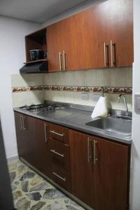a kitchen with a sink and a stove at Aparta- estudio Ziruma 102 in Medellín