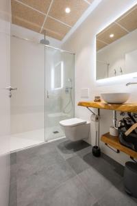 a bathroom with a toilet and a sink and a shower at Elegant Rooms Lasarte in Lasarte