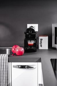 a kitchen counter with a mixer and apples on it at [Ferrara Centro - SABI APT] in Ferrara