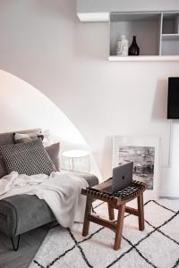 a bedroom with a bed and a laptop on a coffee table at [Ferrara Centro - SABI APT] in Ferrara