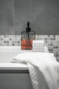 a bottle of soap sitting on top of a bathroom sink at [Ferrara Centro - SABI APT] in Ferrara