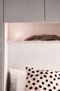 a bedroom with a bed with a candle on a shelf at [Ferrara Centro - SABI APT] in Ferrara