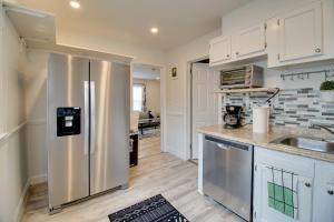 a kitchen with a stainless steel refrigerator at Oxon Hill Retreat about 10 Mi to National Mall! in Oxon Hill