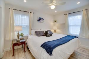 a bedroom with a large bed with a blue blanket at Oxon Hill Retreat about 10 Mi to National Mall! in Oxon Hill