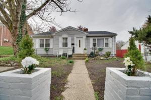 a white house with white flowers in front of it at Oxon Hill Retreat about 10 Mi to National Mall! in Oxon Hill