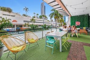 a patio with a table and chairs on a balcony at Tequila Sunrise Hostel Surfers Paradise in Gold Coast