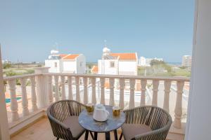 a table and two chairs on a balcony at Blue Crystal Seaview in Protaras