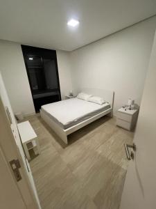 a white bedroom with a bed and a window at Ayla and chill Restricted to families and couples only in Aqaba
