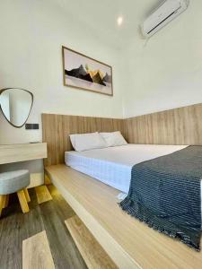 Schlafzimmer mit einem Bett und einem Schreibtisch mit einem Spiegel in der Unterkunft Dhanis House 7 Bedroom Villa in Cibanawak