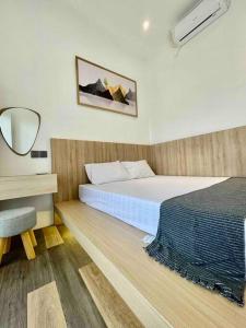 a bedroom with a bed and a desk with a mirror at Dhanis House 8 Bedroom Villa in Cibanawak +16 photos