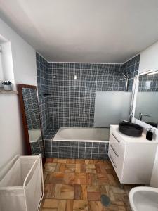 a bathroom with a tub and a toilet and a sink at Seaview, beach front, studio in Alvor