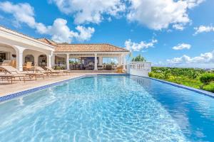 a swimming pool in the backyard of a house at Villa Mer Soleil in Marigot