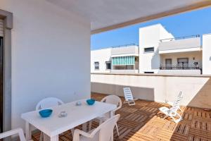 A balcony or terrace at Cozy Flat and Terrace - 2 min from the beach by Sweet Home Puglia Apartments