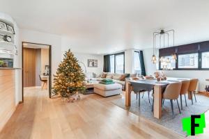 a living room with a christmas tree and a table at Gelsea Blankenberge in Blankenberge