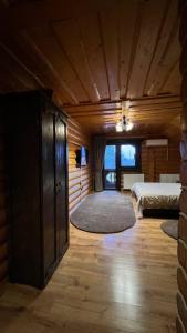 a large room with two beds and a rug at На ставку in Vyzhnytsya +37 photos