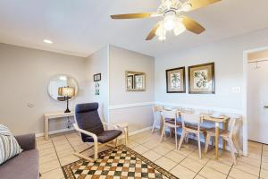 a living room with a dining room table and chairs at Seahorse 612 in Gulf Shores