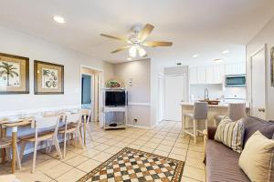 a living room with a couch and a dining room at Seahorse 612 in Gulf Shores