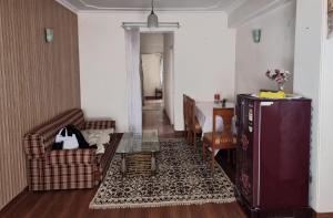 ein Wohnzimmer mit einem Sofa und einem Tisch in der Unterkunft A1 B&B shimla in Shimla