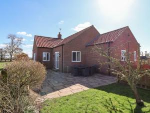 a brick house with a patio in the yard at Middlegate in Ryton