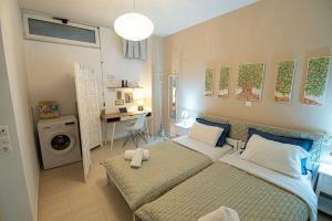 a bedroom with two beds and a desk in it at Landscape Apartment in Kallithéa