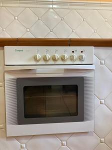 a white stove top oven sitting on a wall at Casa Abedul in Puebla de Lillo