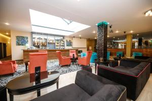 a lobby with couches and chairs and a bar at Parkhotel Carlsbad Inn in Karlovy Vary