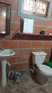 a bathroom with a toilet and a sink at Casa de Campo vía El Peñol Guatapé in Marinilla