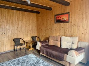 a living room with a couch and a table at Бойківчанка in Yaremche