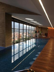 a large swimming pool with a view of a city at Enjoy In Bogotá in Bogotá