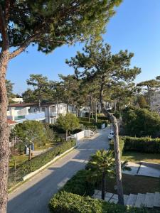 a street with trees on the side of a road at Villa Usignolo in Lignano Sabbiadoro